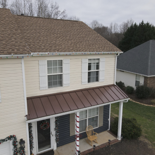 House with brown metal roof and decorations
