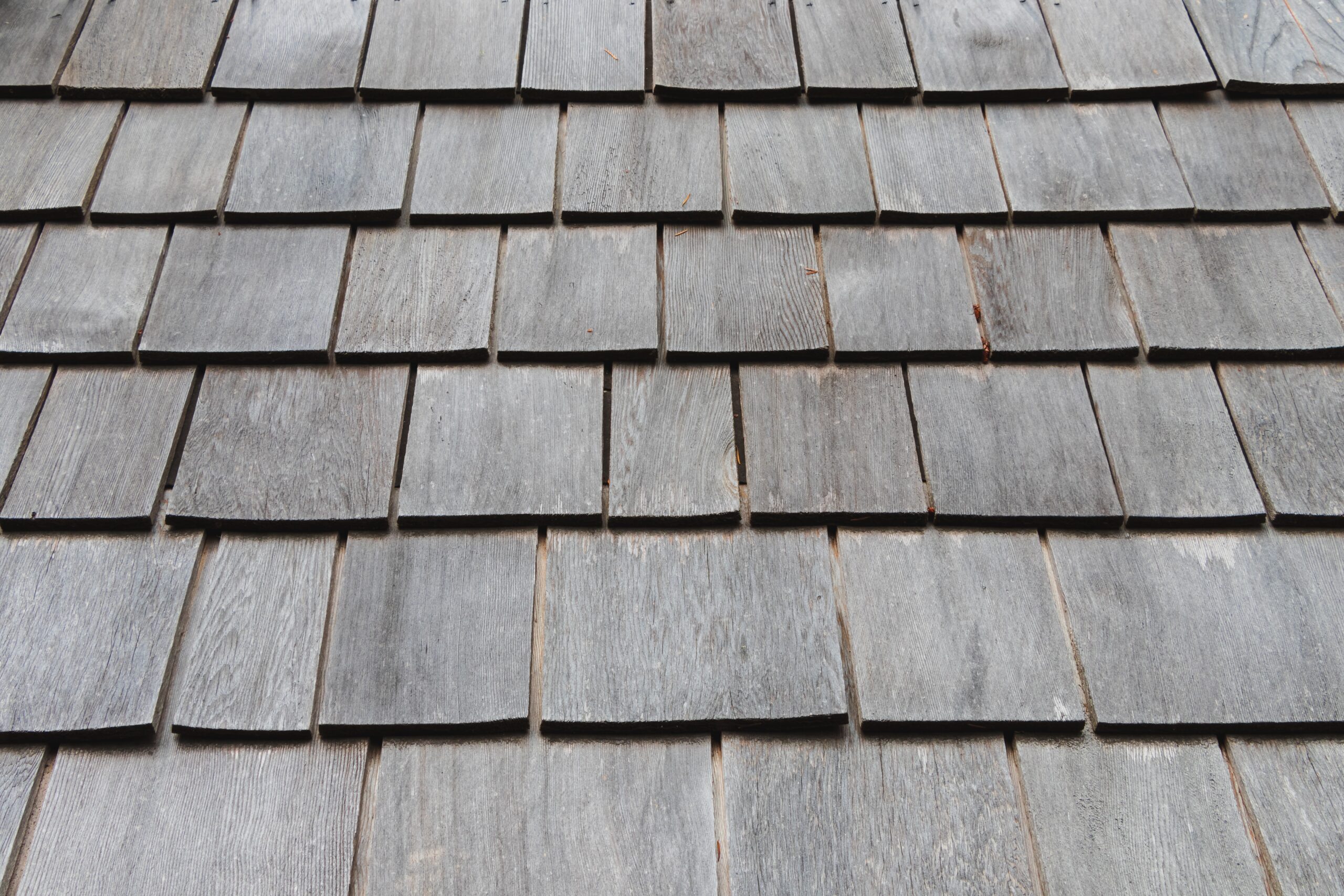 Gray wooden shingles on a roof.