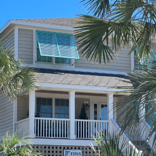 Coastal house with palm trees.