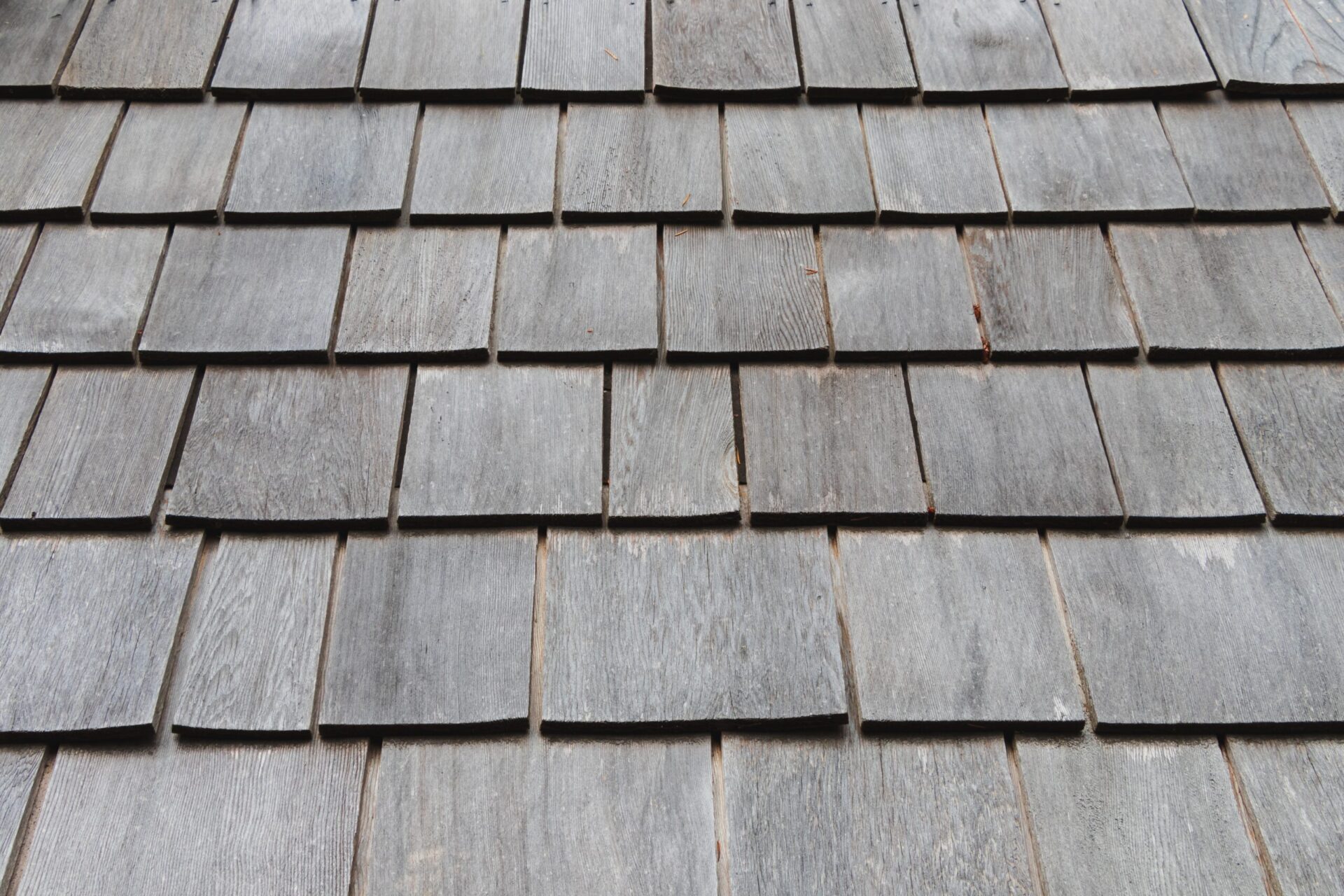 Gray wooden shingles on a roof.