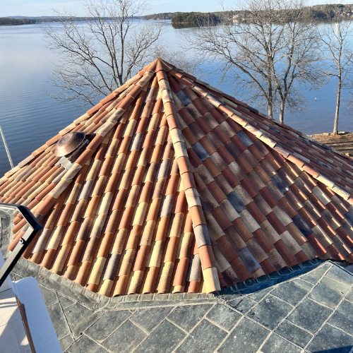 Red tile roof by the lake